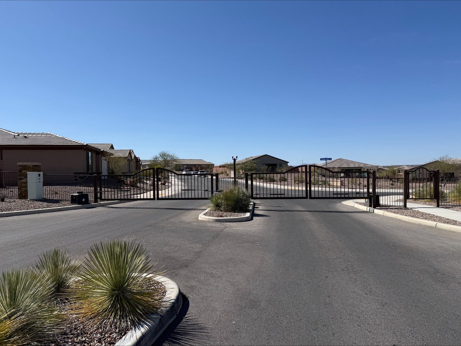 Residential community entry gate with landscaped median — Signal Gates