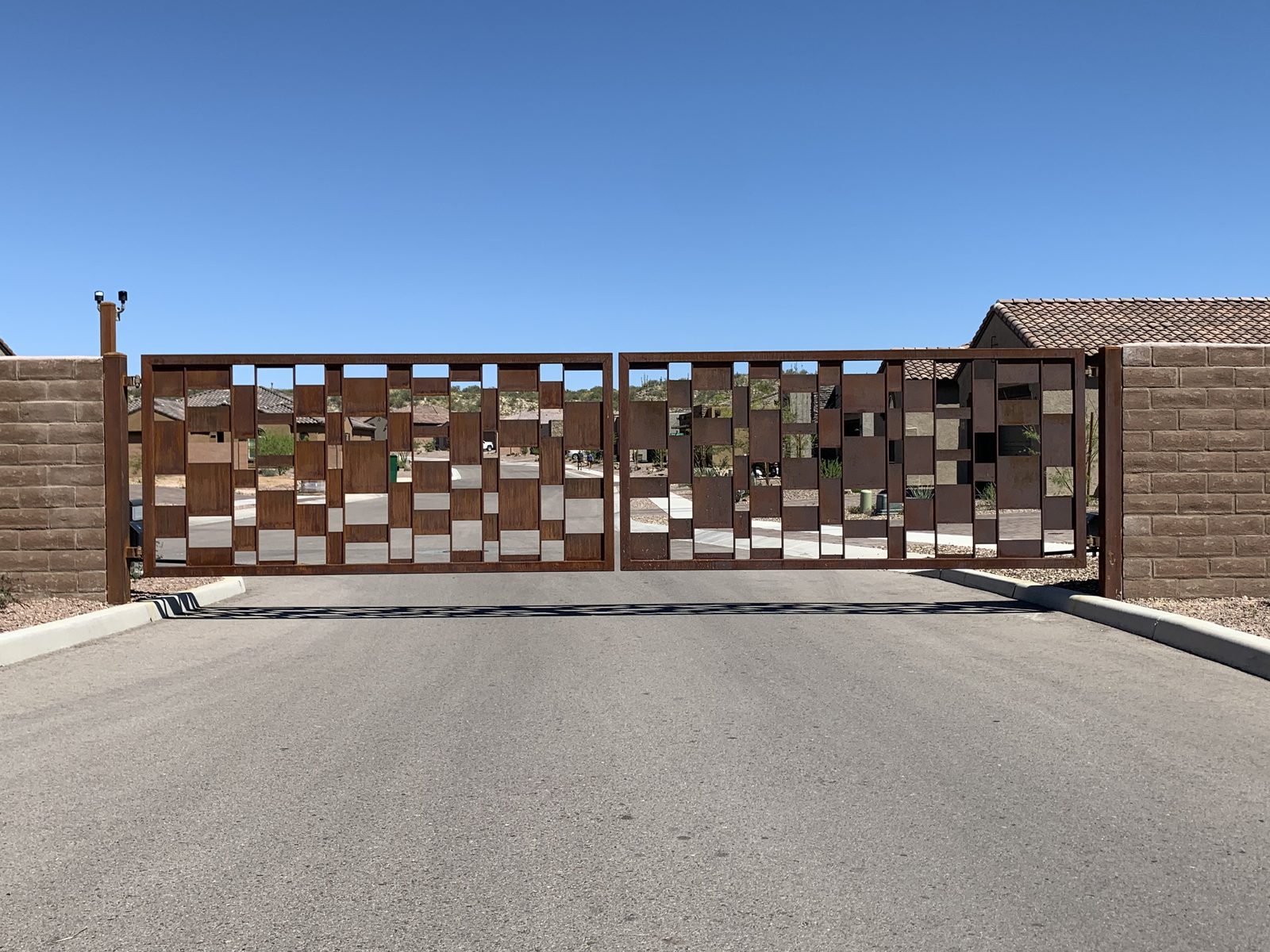 Modern Corten steel community gate with geometric panel design — Signal Gates